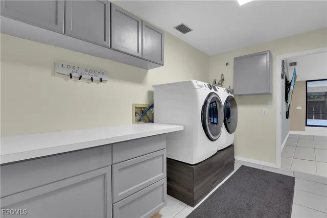 a utility room with sink dryer and washer