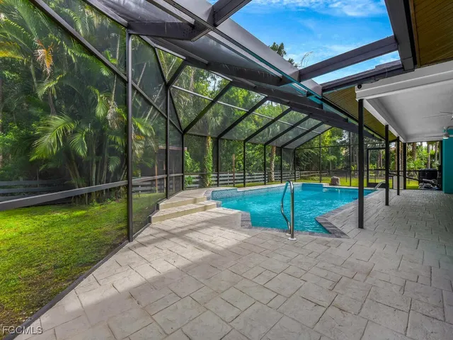 a view of a backyard with swimming pool