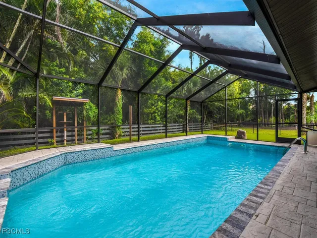 a view of swimming pool with a yard and sitting area