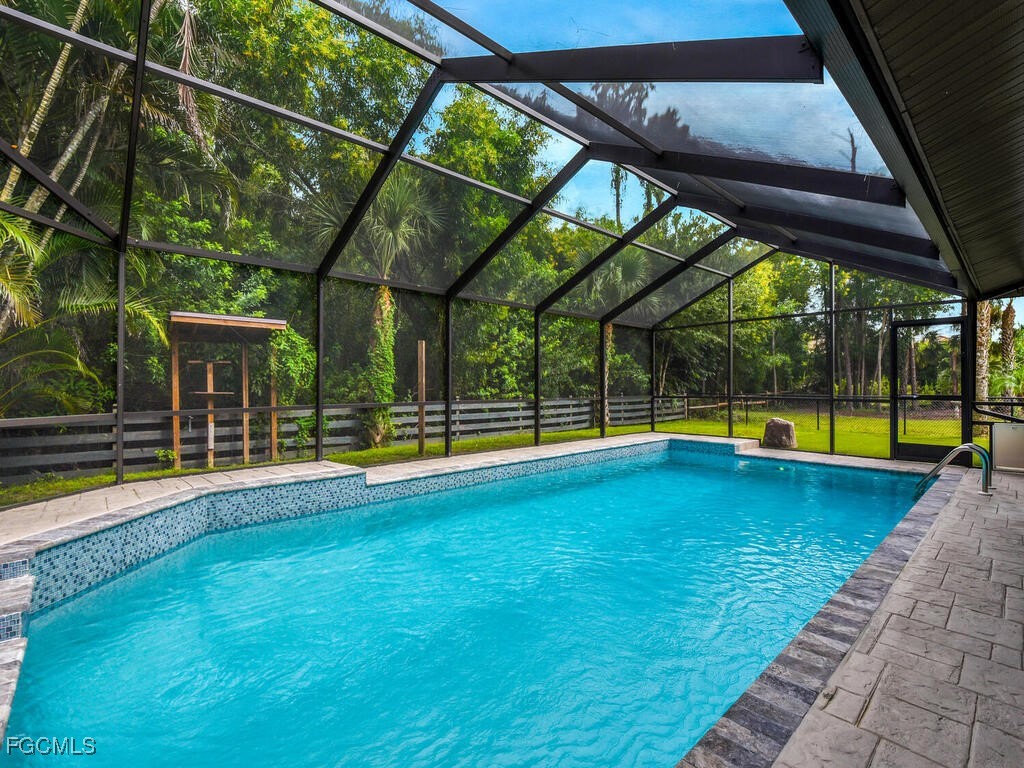 11981 Plantation Road Fort Myers, FL 33966 - Photo 34 of 48 a view of swimming pool with a yard and sitting area