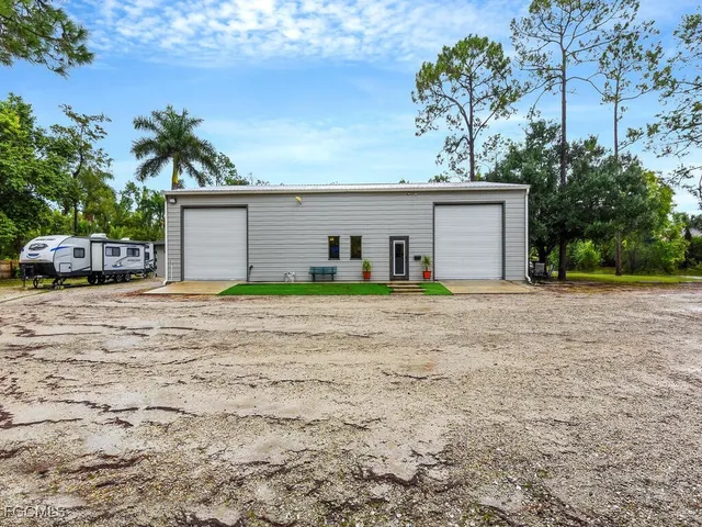 a view of a house with a yard and garage