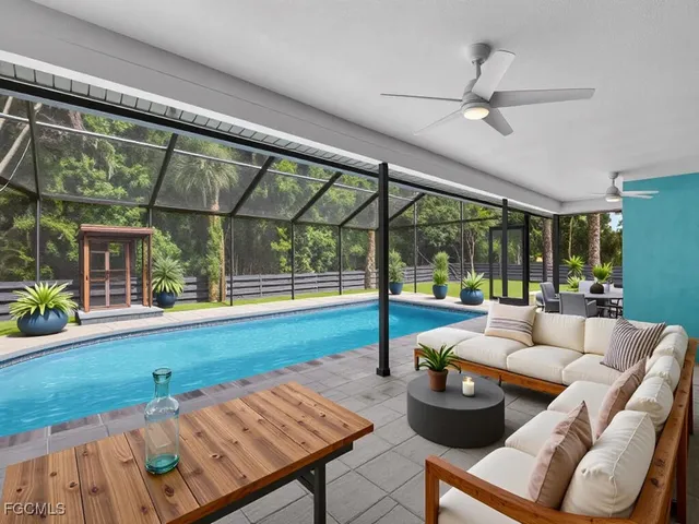 a living room with furniture and a floor to ceiling window