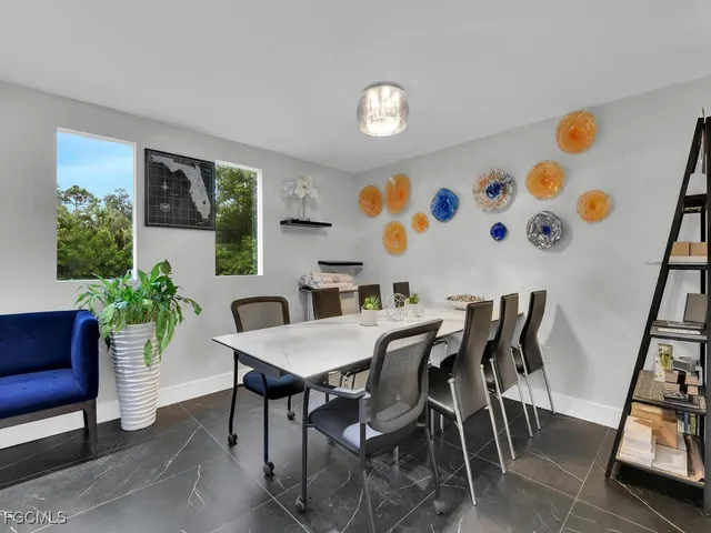 a view of a dining room with furniture and a potted plant