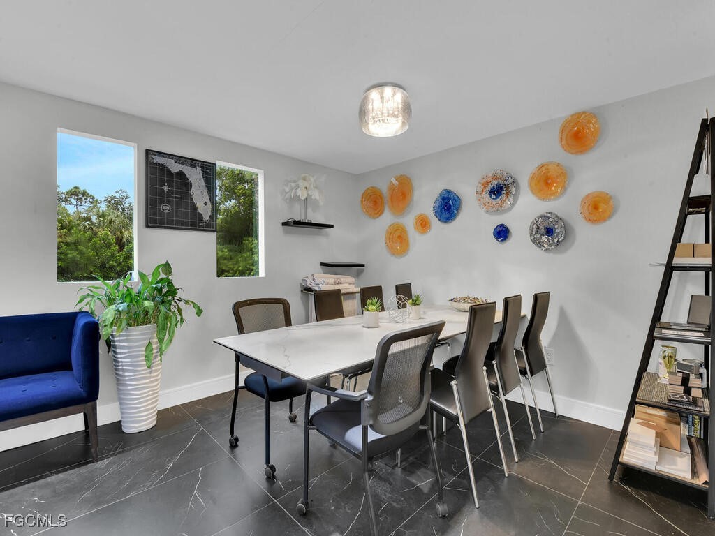 11981 Plantation Road Fort Myers, FL 33966 - Photo 41 of 48 a view of a dining room with furniture and a potted plant