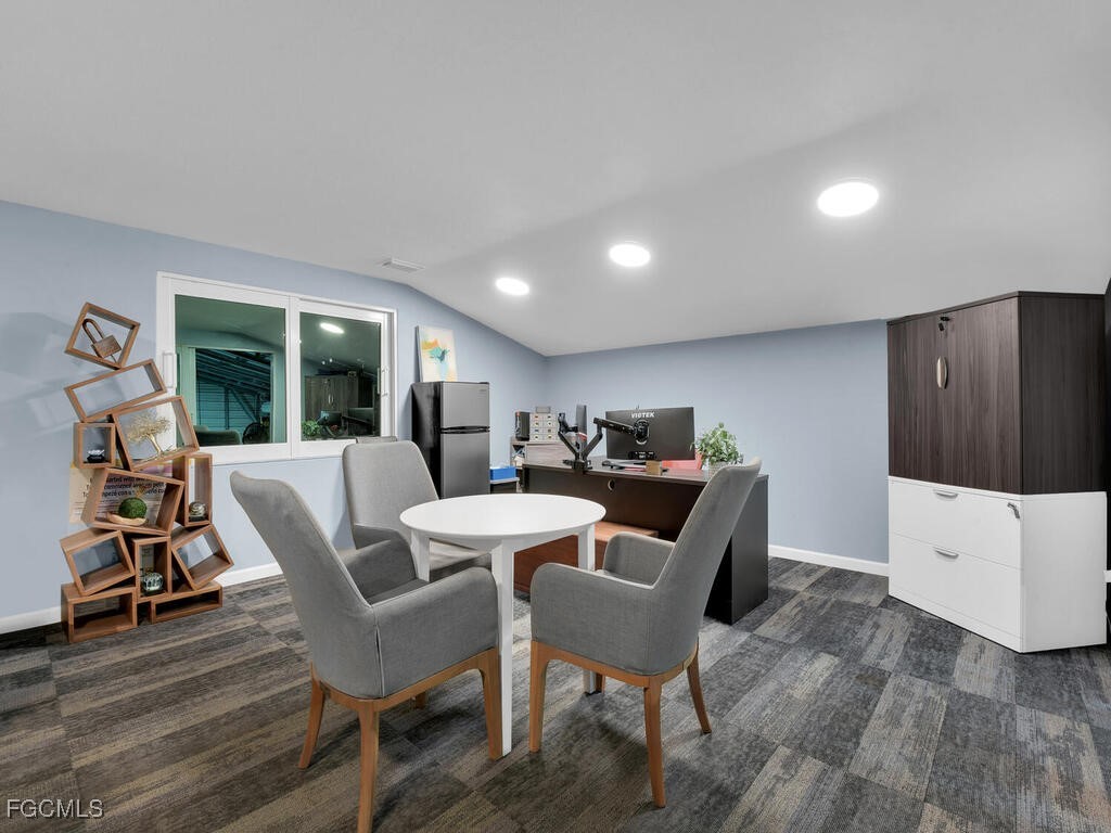 11981 Plantation Road Fort Myers, FL 33966 - Photo 45 of 48 a view of a dining room with furniture a rug and wooden floor