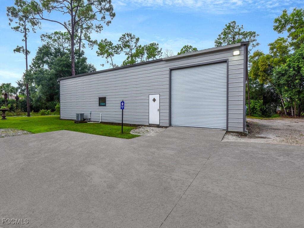 11981 Plantation Road Fort Myers, FL 33966 - Photo 46 of 48 a view of a house with garage and yard