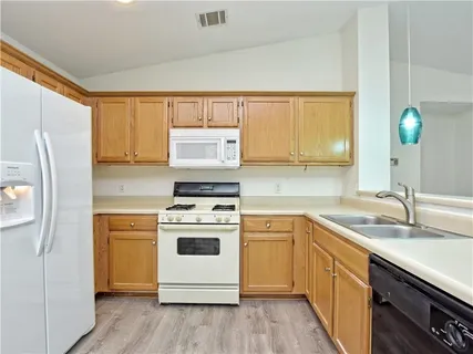 a kitchen with a white cabinets and white appliances