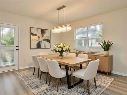 a dining room with furniture a window and wooden floor