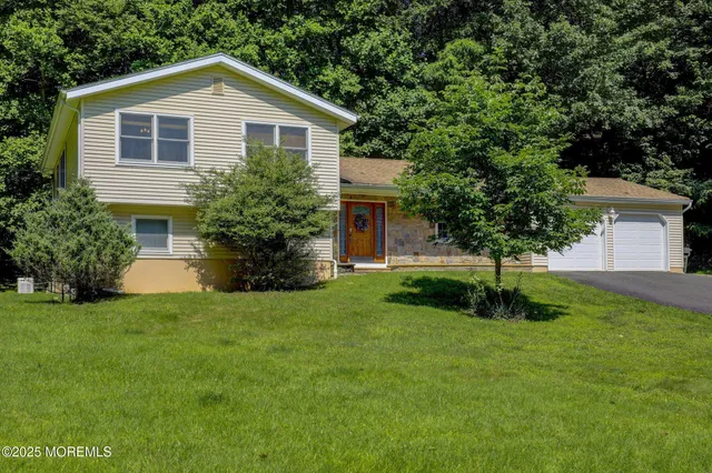 a front view of house with yard and green space