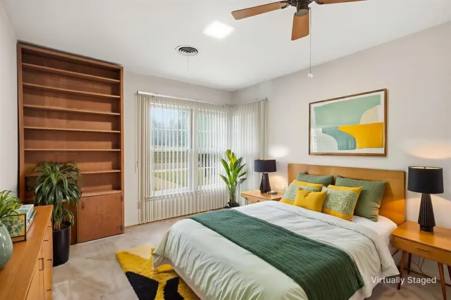 a bedroom with a bed and a potted plant