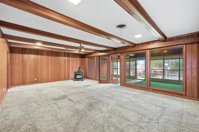 a view of an empty room with a fireplace and a window