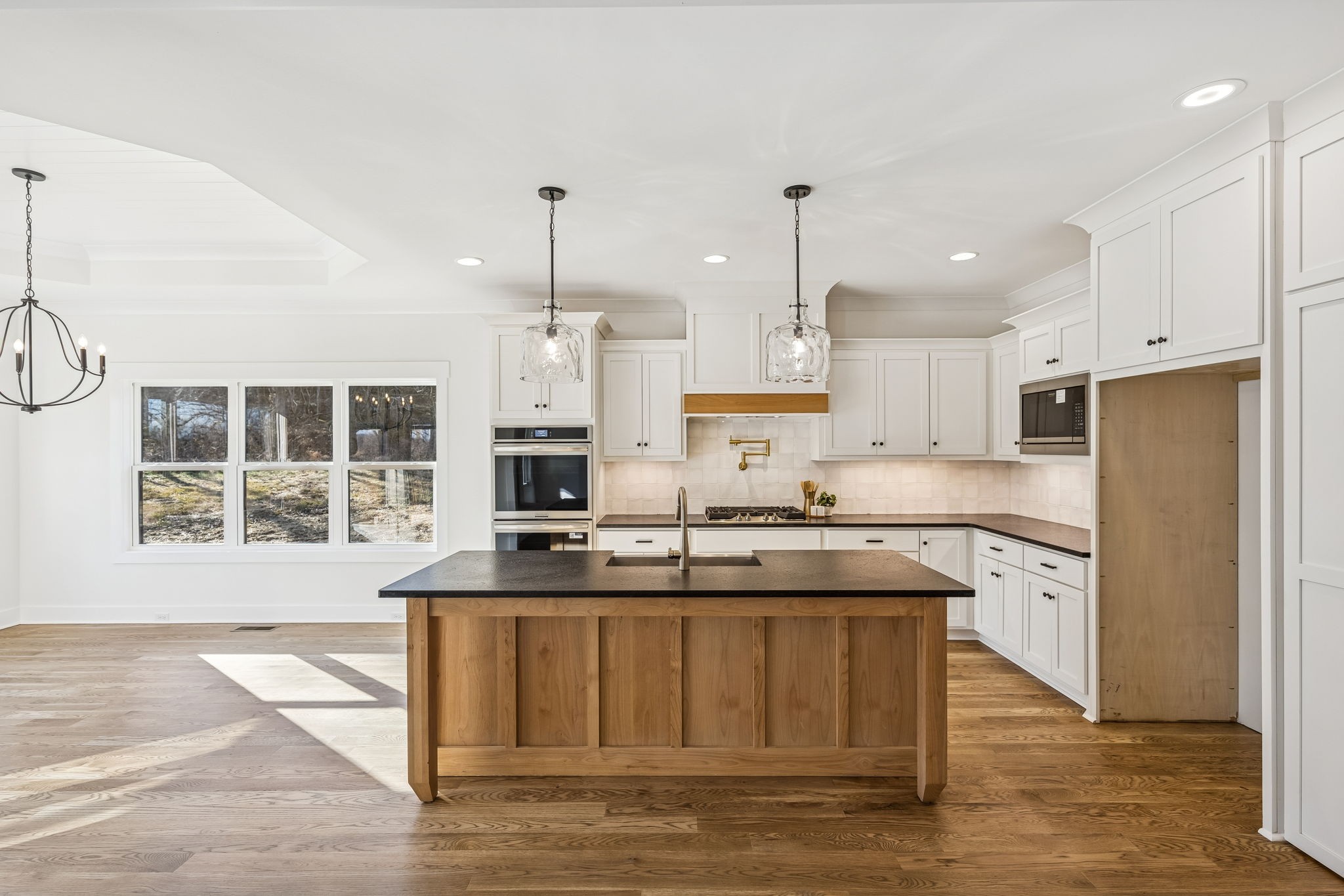 13841 Cainsville Road Lebanon, TN 37090 - Photo 18 of 81 a kitchen with stainless steel appliances granite countertop a stove a sink a refrigerator and white cabinets with wooden floor