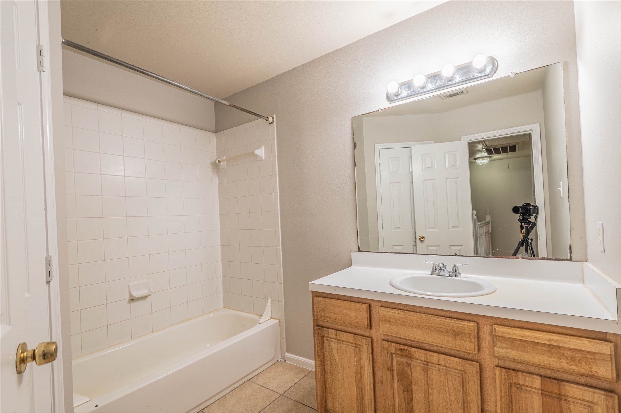 11906 Chetman Drive, Unit A Houston, TX 77065 - Photo 14 of 15 a bathroom with a bathtub shower sink vanity and mirror