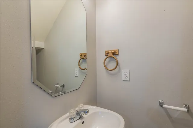 a bathroom with a sink and mirror
