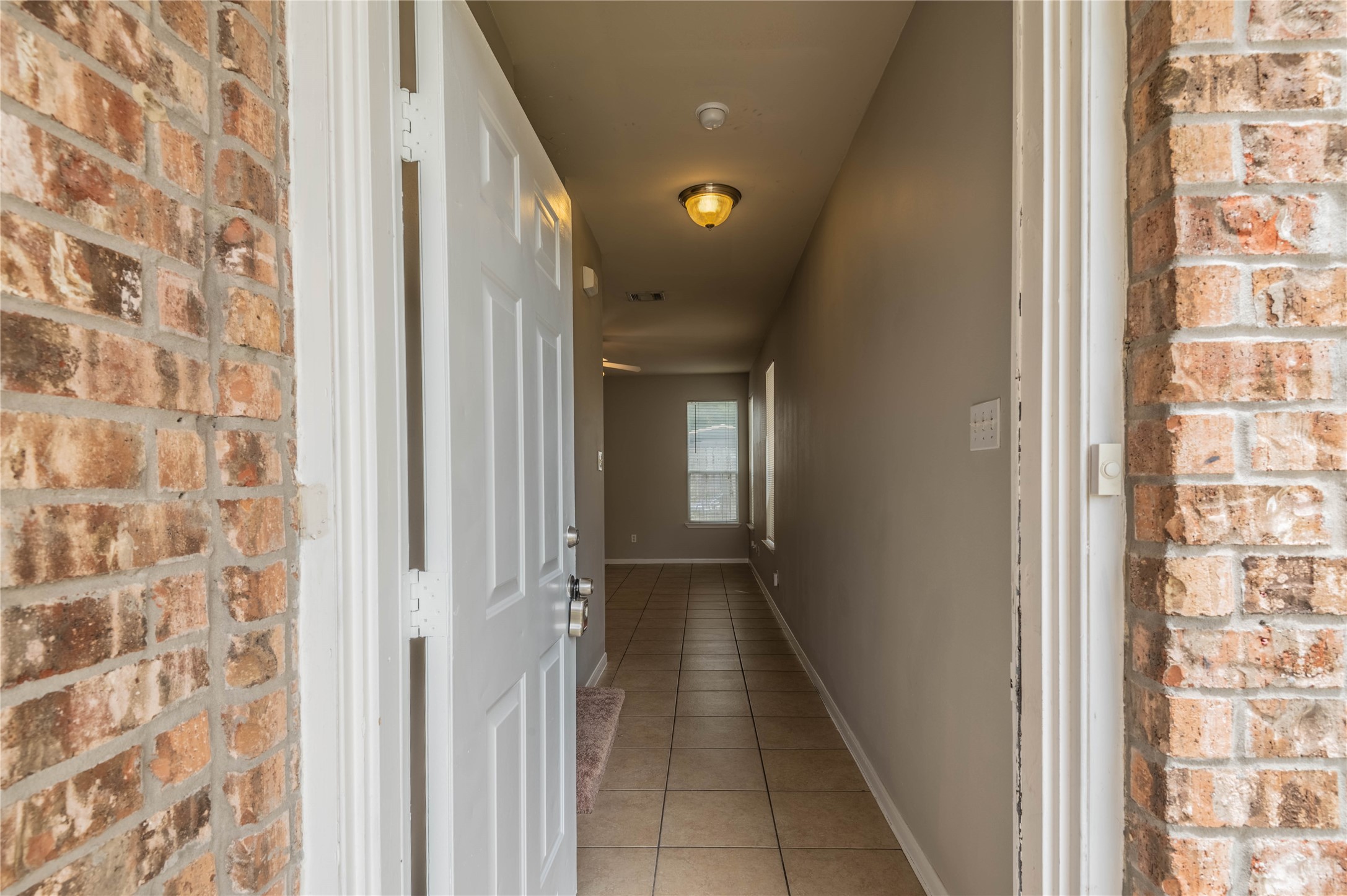 11906 Chetman Drive, Unit A Houston, TX 77065 - Photo 2 of 15 a view of a hallway with wooden floor and a bathroom