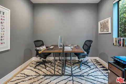 a work room with furniture and wooden floor