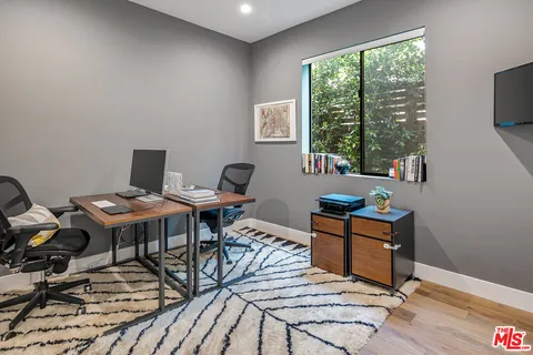 a workspace with furniture hardwood and a window