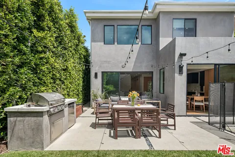 a view of a patio with table and chairs and potted plants