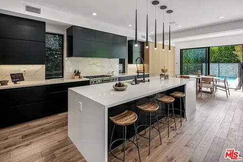 a kitchen with a sink a counter space and appliances