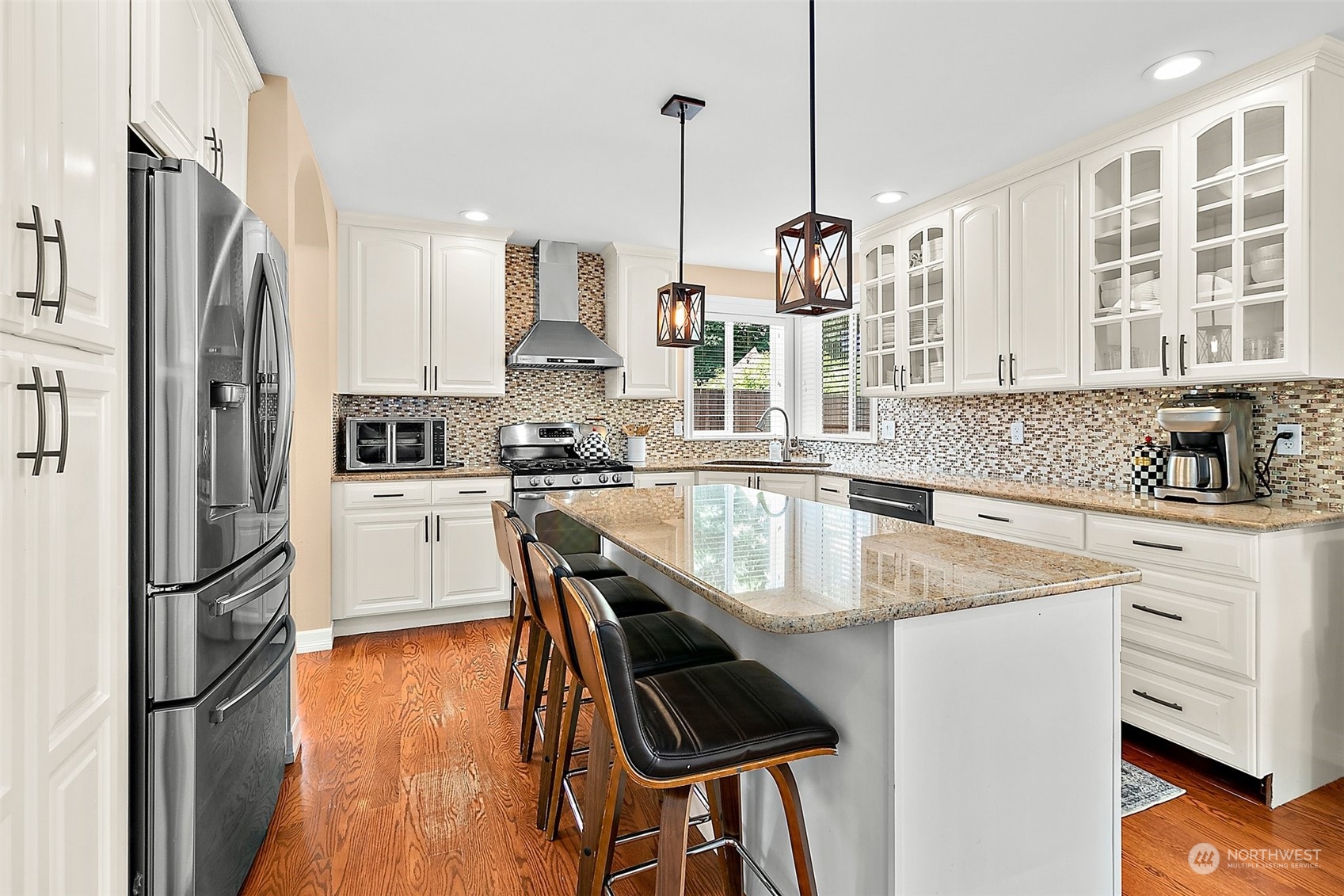 9604 South 236th Place Kent, WA 98031 - Photo 11 of 39 a kitchen with stainless steel appliances granite countertop a sink a stove a refrigerator and island with wooden floor