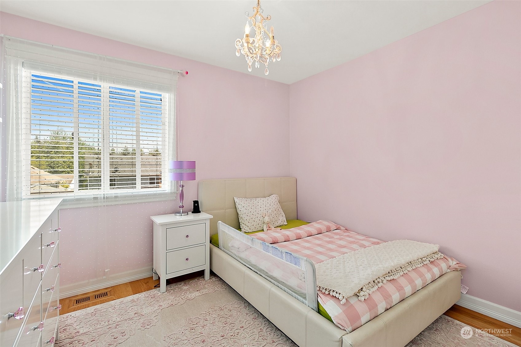9604 South 236th Place Kent, WA 98031 - Photo 19 of 39 a bedroom with a bed next to a window and a chandelier