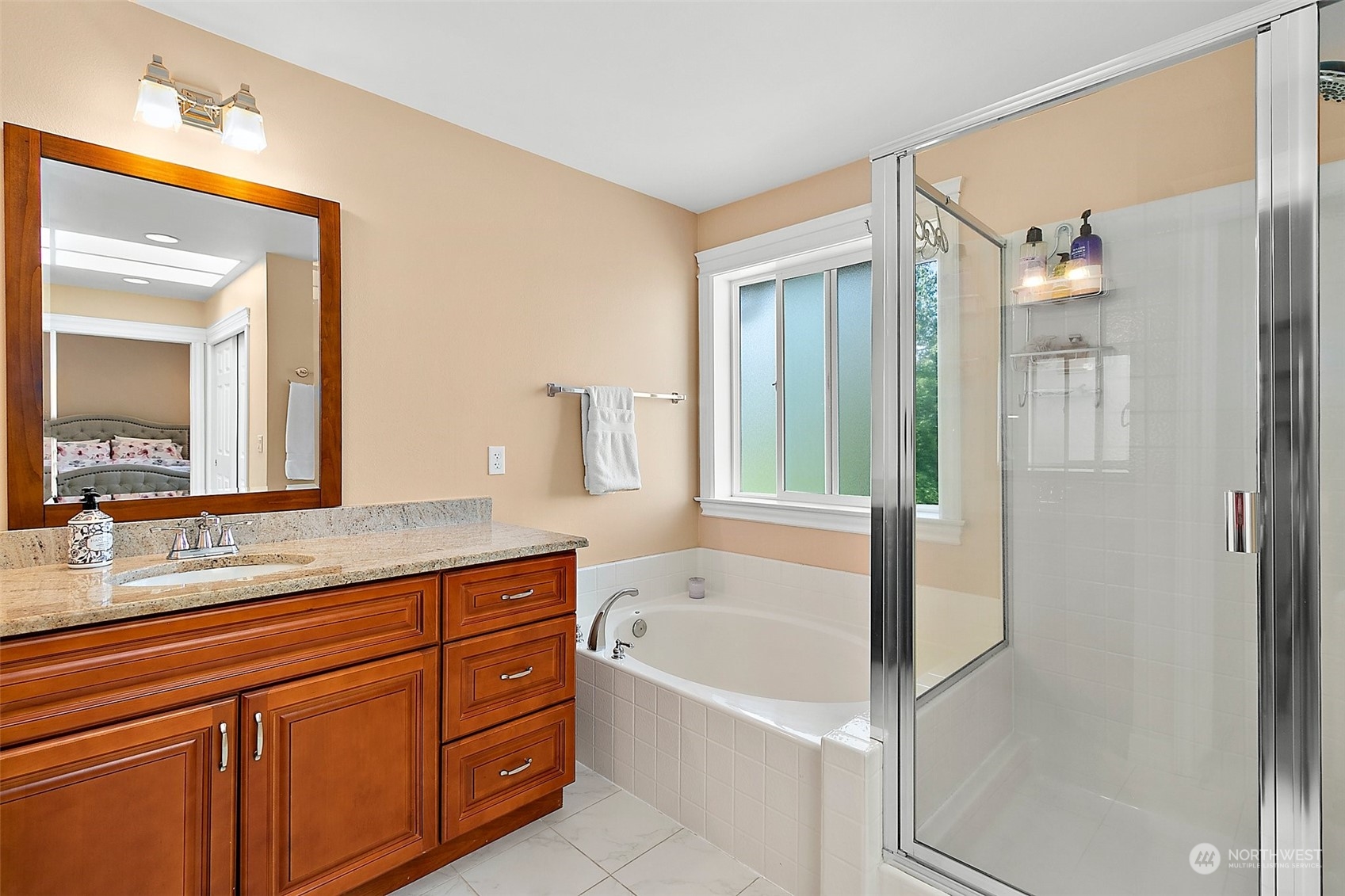 9604 South 236th Place Kent, WA 98031 - Photo 27 of 39 a spacious bathroom with a granite countertop tub sink and mirror