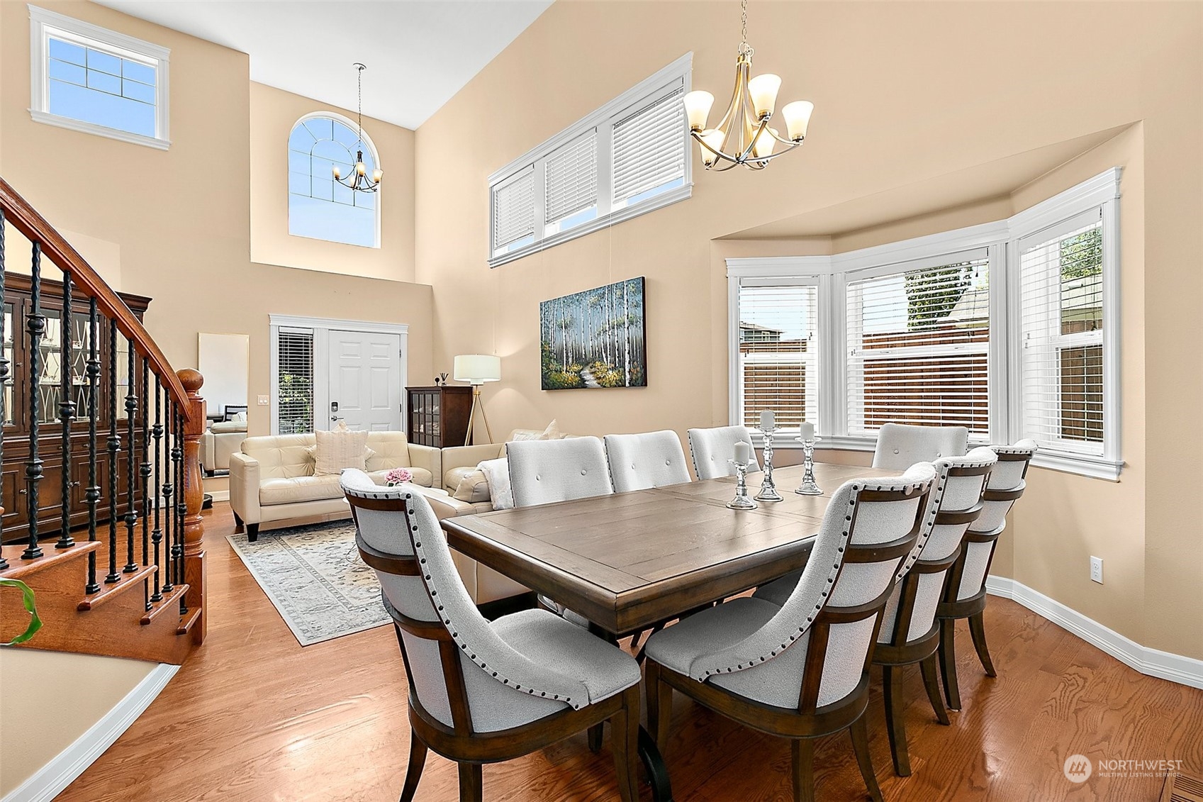 9604 South 236th Place Kent, WA 98031 - Photo 8 of 39 a view of a dining room with furniture a chandelier and wooden floor