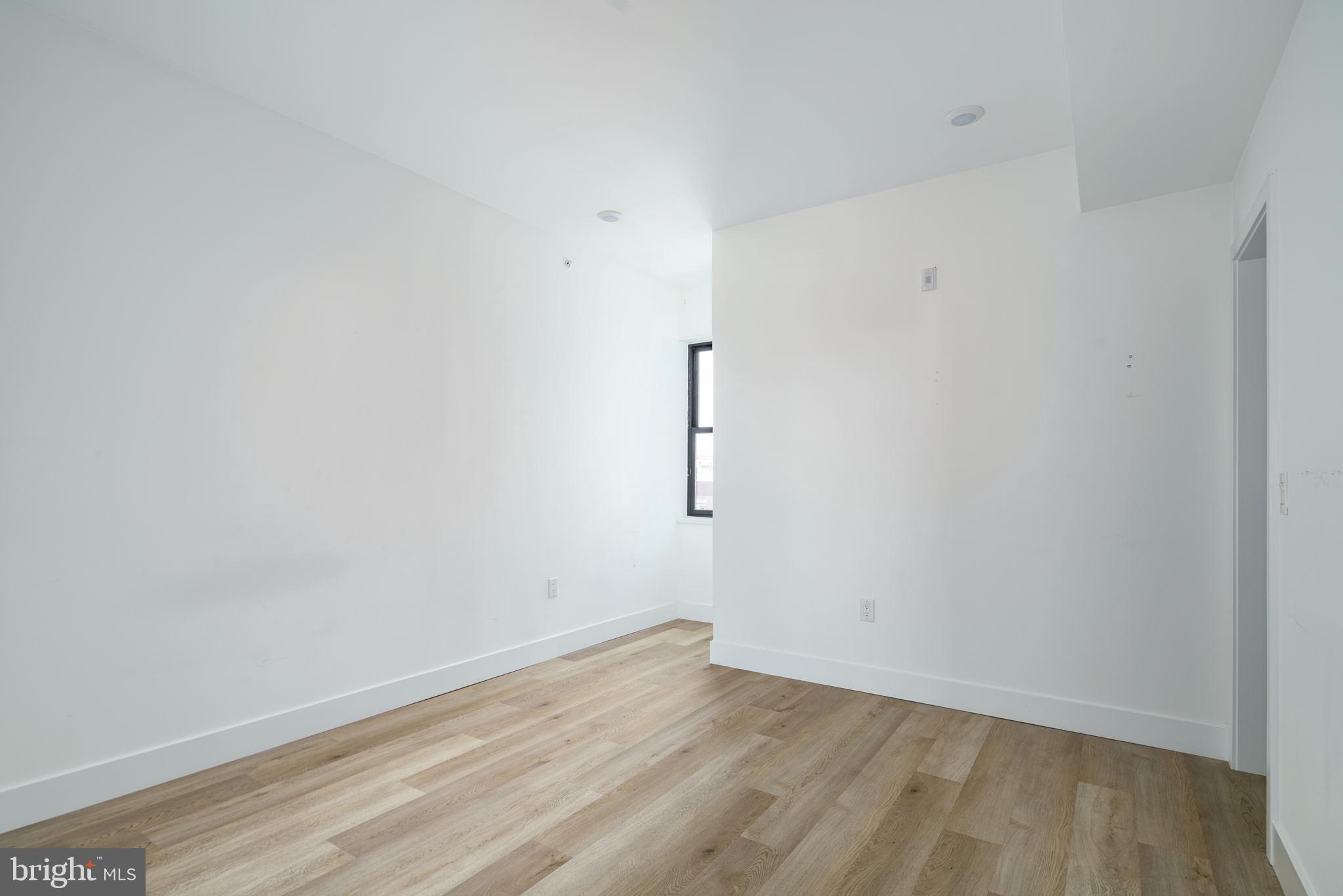930 North 2nd Street, Unit 3 Philadelphia, PA 19123 - Photo 13 of 20 an empty room with wooden floor and windows