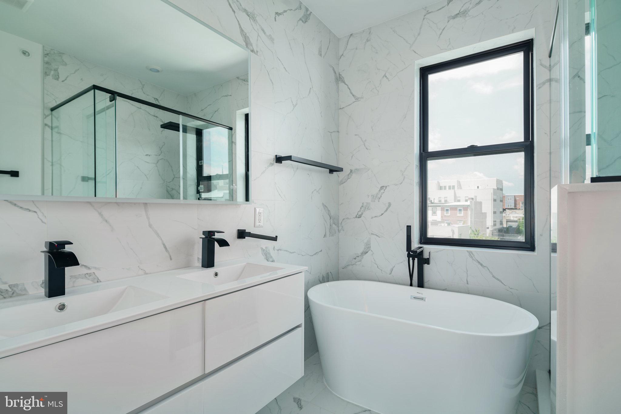 930 North 2nd Street, Unit 3 Philadelphia, PA 19123 - Photo 15 of 20 a bathroom with a bathtub a sink and mirror