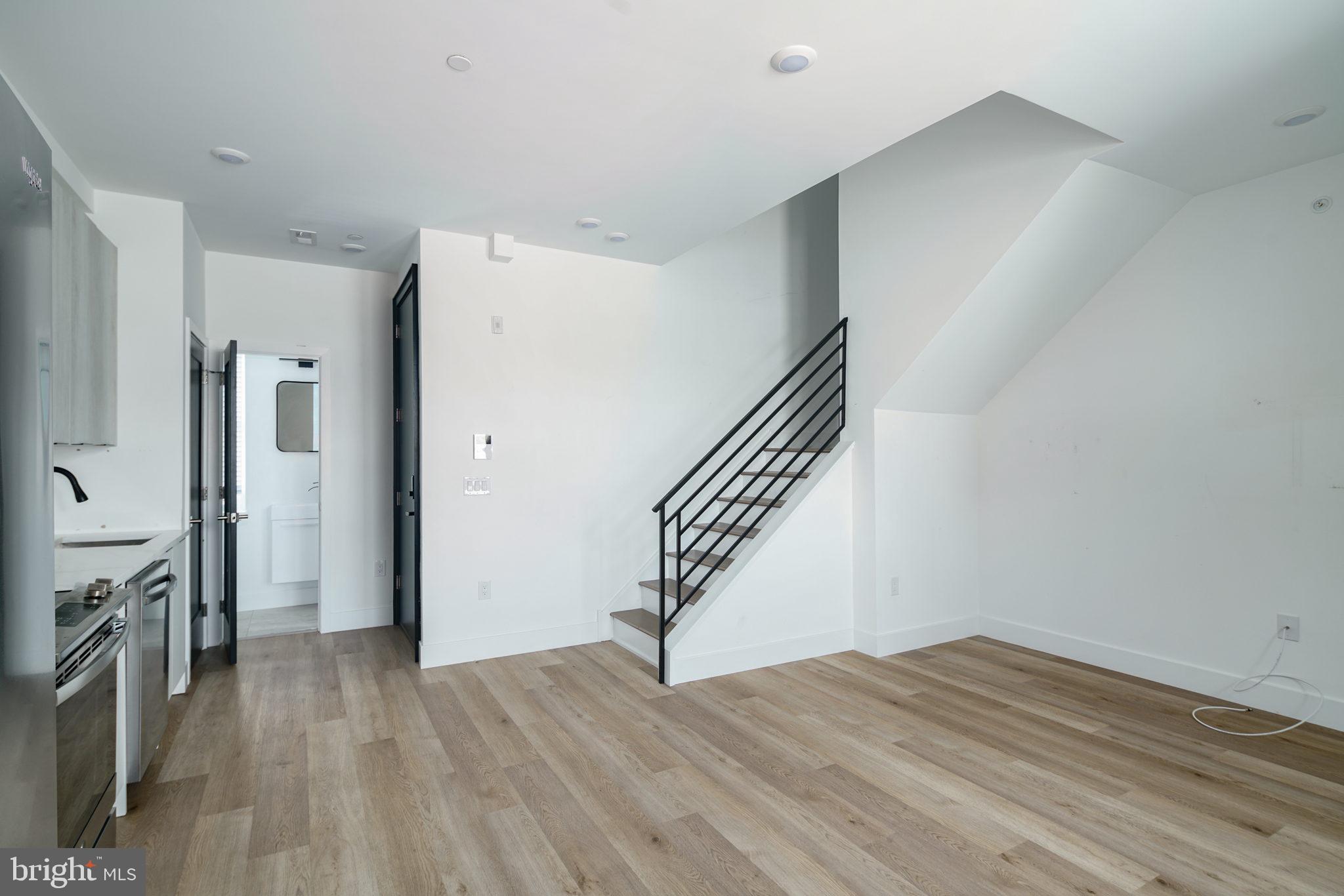 930 North 2nd Street, Unit 3 Philadelphia, PA 19123 - Photo 4 of 20 a view of a livingroom with wooden floor and stairs