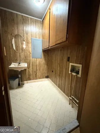 a view of an empty room with wooden floor and cabinet