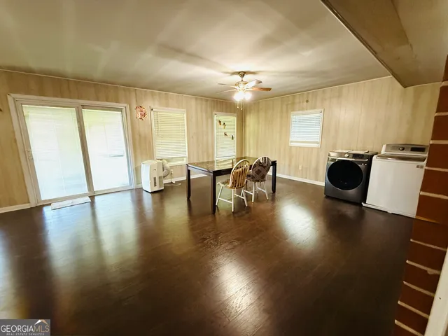 a view of a work space with wooden floor and furniture