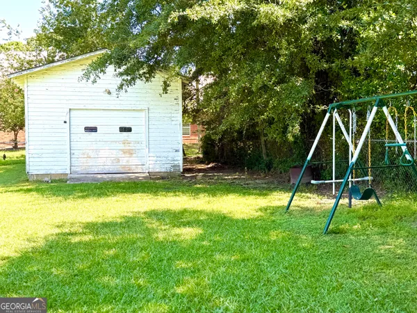 a view of a house with a backyard
