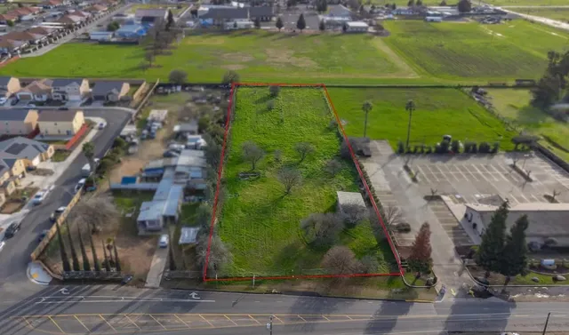 an aerial view of a house with a yard