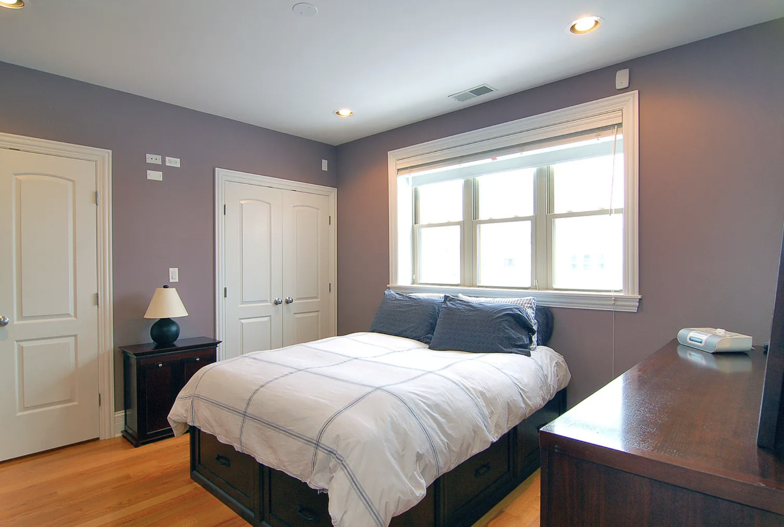 Undisclosed Address Chicago, IL 60613 - Photo 7 of 8 a bedroom with a bed and a window