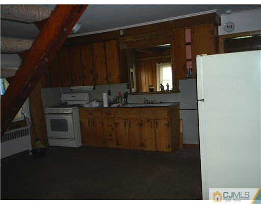 935 New Dover Road Edison, NJ 08820 - Photo 3 of 9 a kitchen with a sink and cabinets