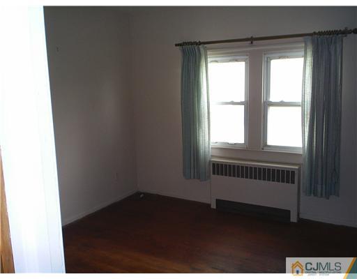 935 New Dover Road Edison, NJ 08820 - Photo 6 of 9 a view of an empty room with a window