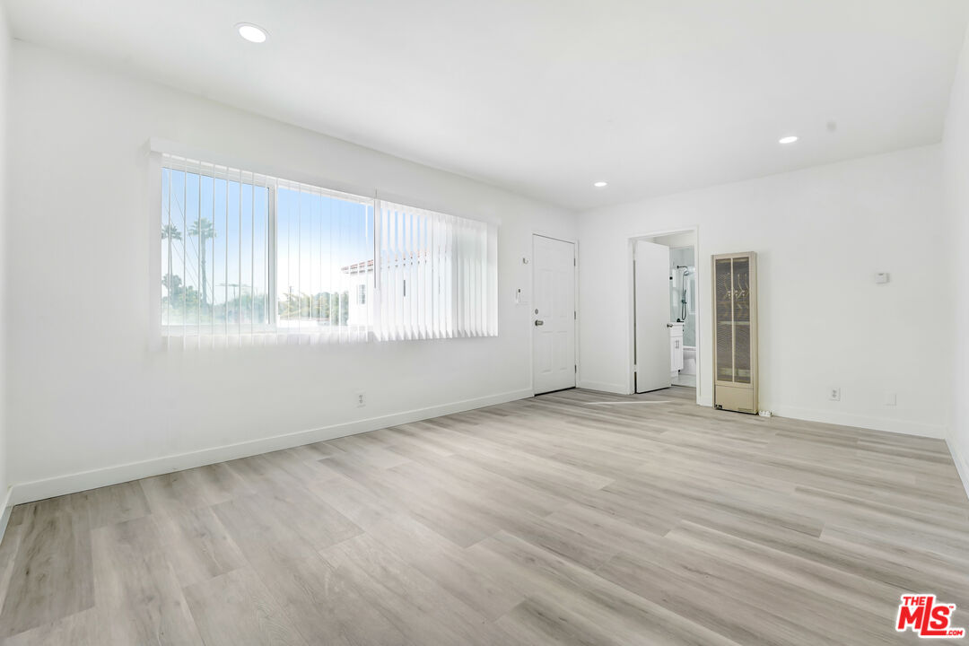 1255 26th Street, Unit 1 Santa Monica, CA 90404 - Photo 2 of 10 a view of an empty room with wooden floor and window