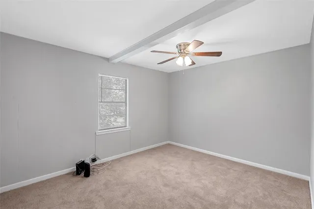 an empty room with closet and window