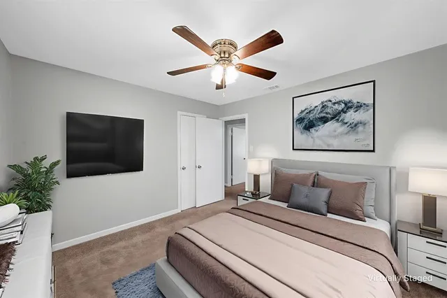 a bedroom with a large bed and a flat screen tv