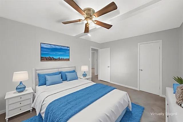 a bedroom with a bed and a painting on the wall