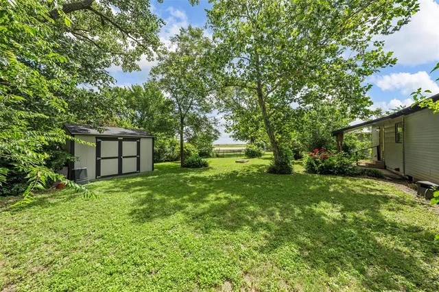 a view of house with backyard