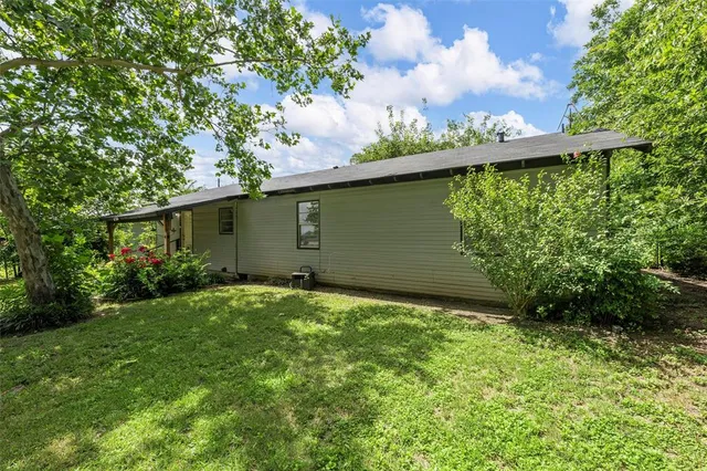 a backyard of a house with lots of green space