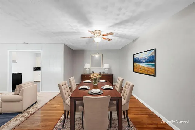 a view of a dining room with furniture and wooden floor