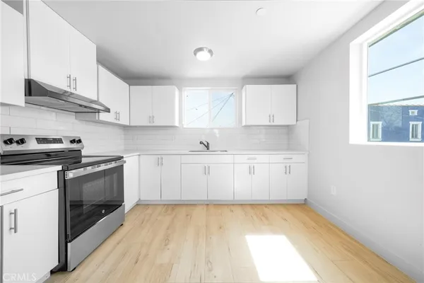 a view of a kitchen with electric appliances