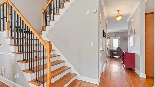 a view of a hallway with wooden floor and staircase