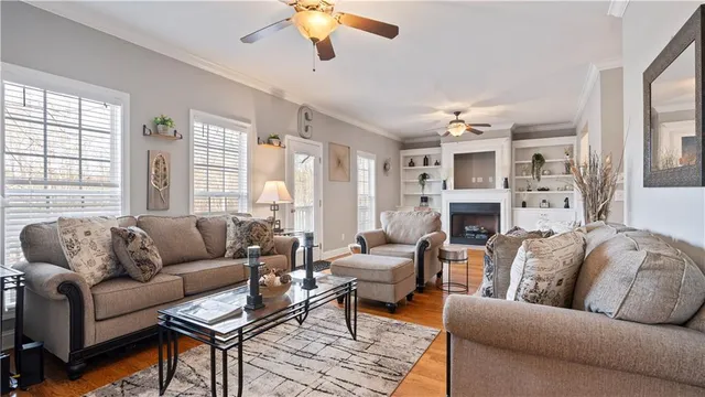 a living room with furniture a fireplace and a large window