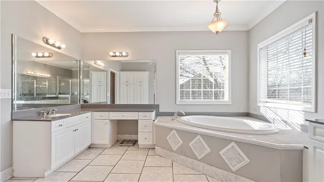 a spacious kitchen with a sink and cabinets