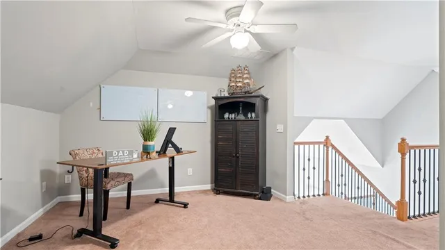 a view of a workspace with furniture and a chandelier fan