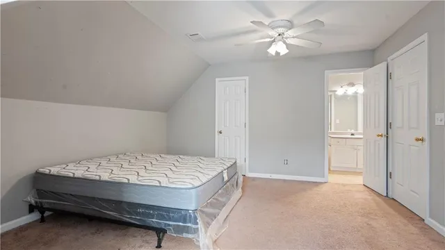 a bedroom with a bed and a ceiling fan